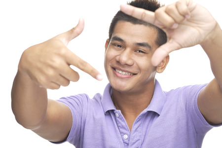 Man smiling at camera, making finger frameの写真素材