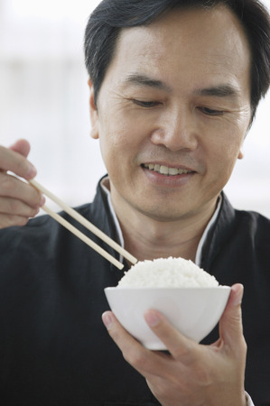 Man eating riceの写真素材
