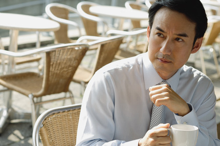 Businessman in cafe holding mugの写真素材