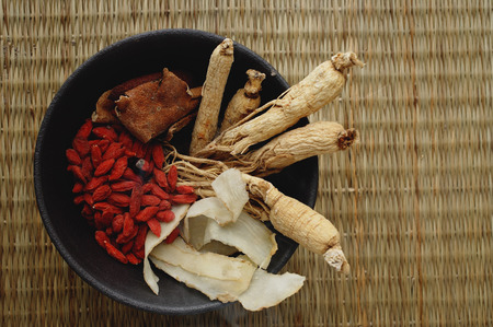 Bowl filled with Chinese medicinal herbs, high angle viewの写真素材