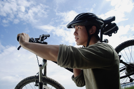 Man carrying bicycleの写真素材