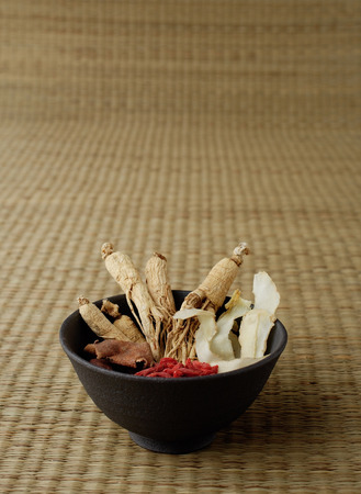 Bowl filled with Chinese medicinal herbs, still lifeの写真素材