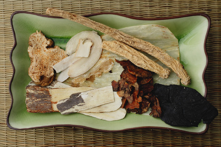 Plate of Chinese medicinal herbs, close-upの写真素材