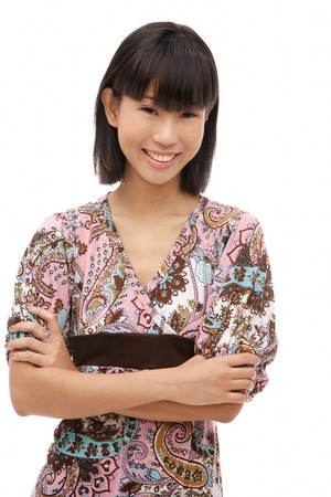 Young woman with arms crossed, smiling at cameraの写真素材