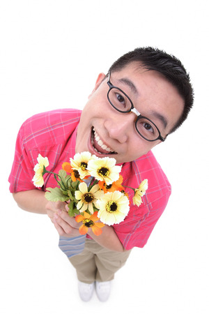 Man holding flower bouquet, smiling at cameraの写真素材