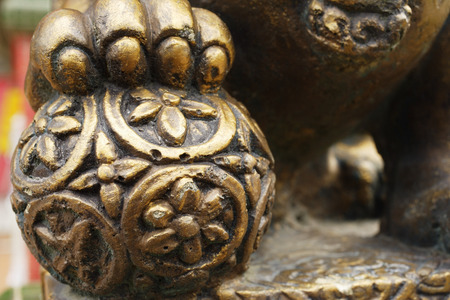 Close up of statue of lion's paw on orbの写真素材