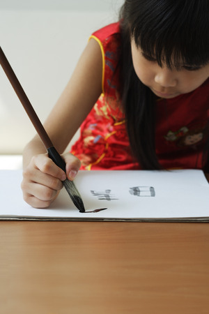Young girl practicing calligraphyの写真素材