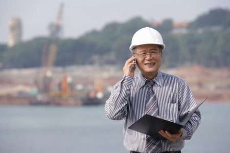 Man with helmet, talking on the phoneの写真素材