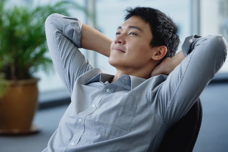 A man relaxes at his deskの写真素材