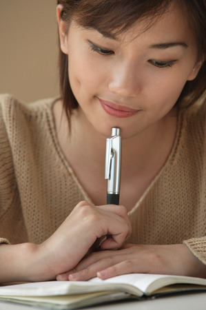 Young woman looking at notebookの写真素材