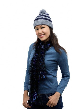 Young woman wearing winter hat and scarf, smiling at cameraの写真素材