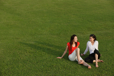 Two women relaxing in the parkの写真素材