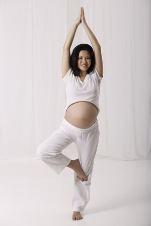 Pregnant woman practicing yogaの写真素材