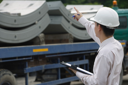 Man with hard helmet and clipboard