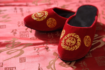 Still life of pair of red shoes on oriental design fabricの写真素材