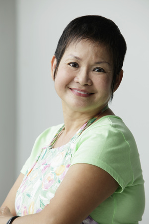 Head shot of mature Chinese woman smilingの写真素材
