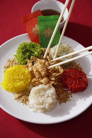 Plate of raw fish salad also known as 'Yu Sheng' or 'Lo Hei'の写真素材