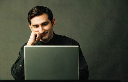 Man using laptop, smilingの写真素材