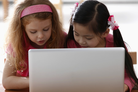 Two young girls looking at laptopの写真素材