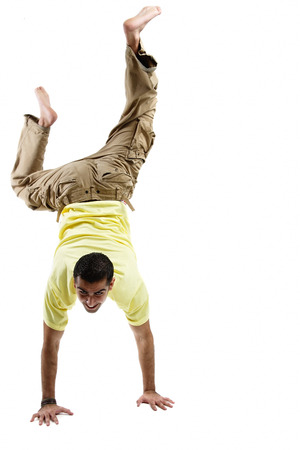 Young man balancing on his hands, legs upの写真素材