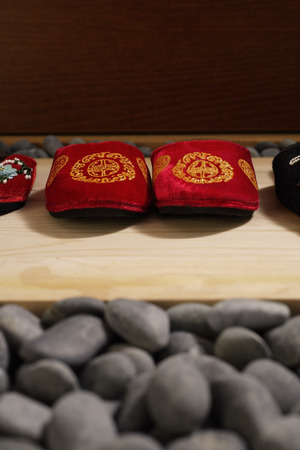 front view of red oriental slippers at door front