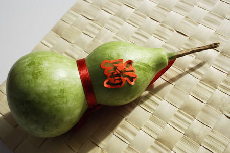 Still life of bottle gourd on weaved matの写真素材