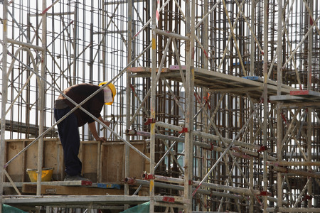 Construction worker in building frame.
