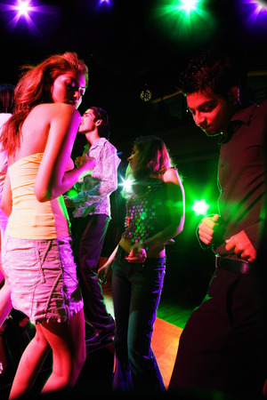 Young adults dancing in clubの写真素材