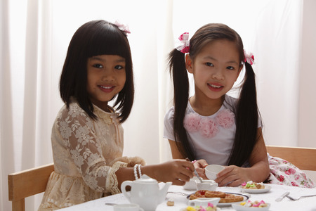 two little girls having a tea paryの写真素材