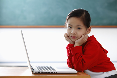 Young Chinese girl with laptopの写真素材
