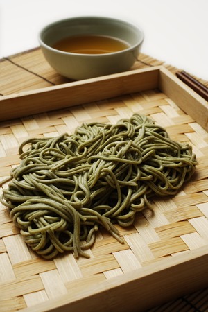 cooked soba noodles with sauce on the sideの写真素材
