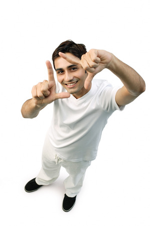Young man looking up at camera, making hand sign, 'L'の写真素材