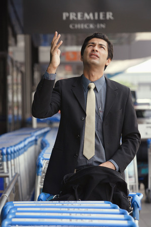 Man gesturing and looking upの写真素材