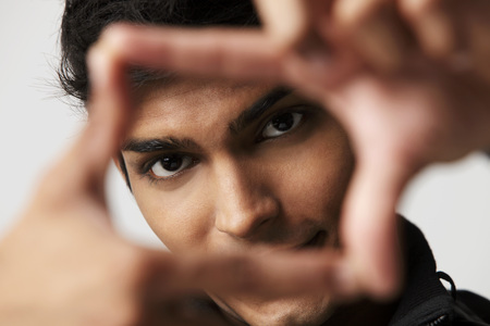 head shot of young man making a frame with his fingersの写真素材