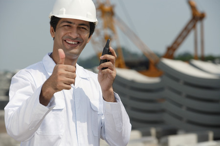 Man in work uniform gives thumb upの写真素材