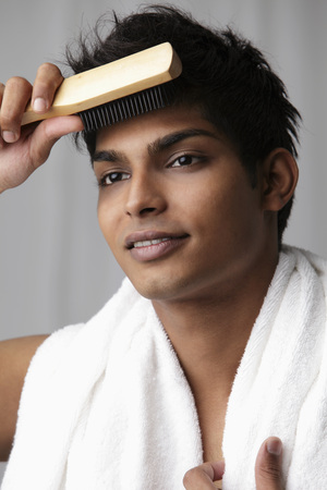 young man brushing his hair