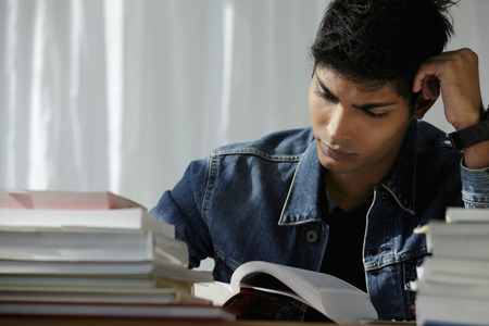 young man reading a book, studyingの写真素材