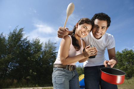 Young couple camping and cooking in the wildernessの写真素材