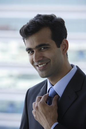 Head shot of Indian businessman smiling.の写真素材