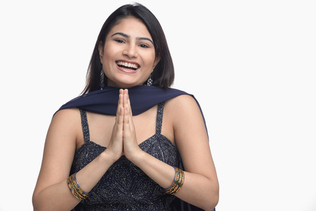 Woman in traditional Indian clothing, hands together, smilingの写真素材