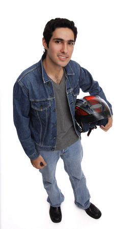 Man carrying motorcycle helmet, looking up at cameraの写真素材