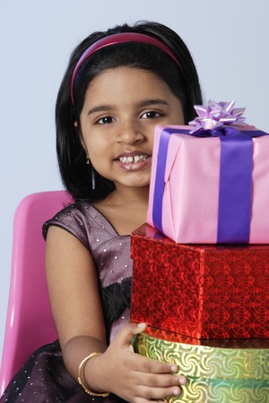 Little girl holding giftsの写真素材