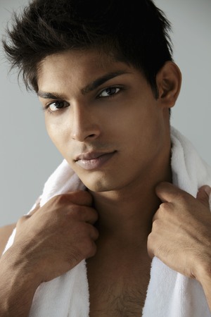 head shot of  young man with towel around his neckの写真素材