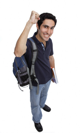 College student looking at camera, raising a fist, smilingの写真素材