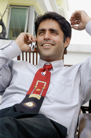 Businessman using mobile phone, smilingの写真素材