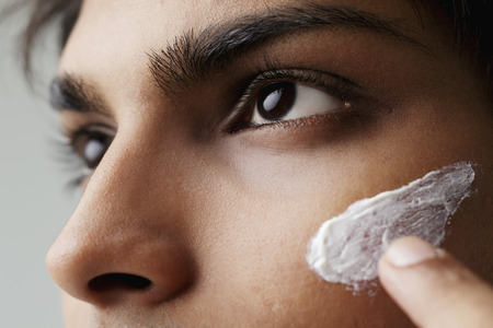 close up of lotion on young man's faceの写真素材