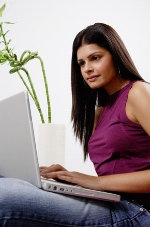 Woman sitting, using laptopの写真素材