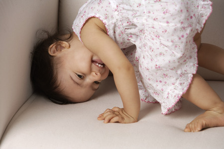 toddler playing on the couchの写真素材