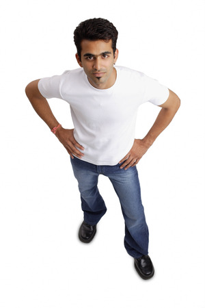 Man looking at camera, hands on hipの写真素材