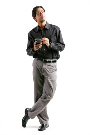 Businessman holding PDA, looking awayの写真素材